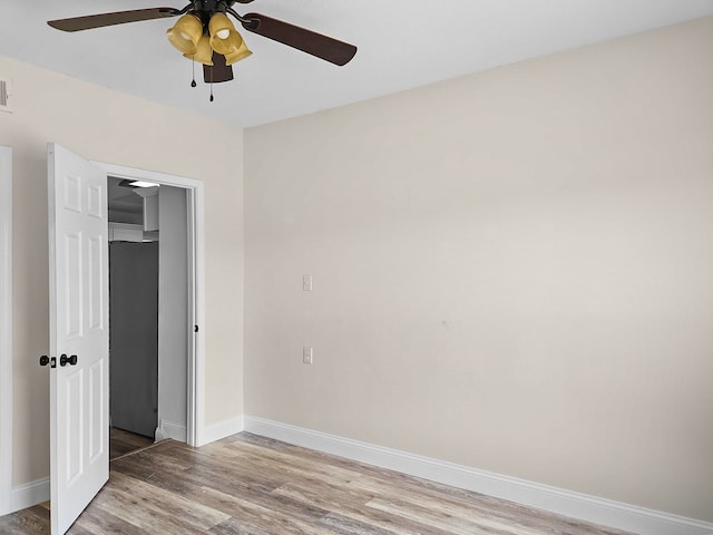 spare room featuring ceiling fan and wood-type flooring