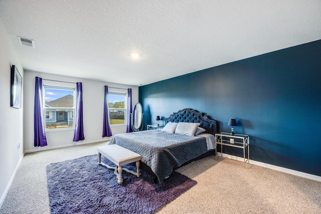 carpeted bedroom with a textured ceiling