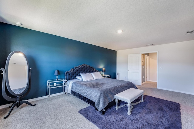 carpeted bedroom with a textured ceiling