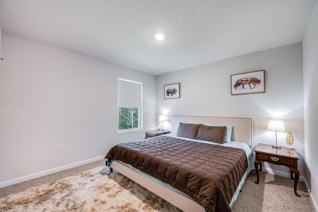 bedroom with carpet flooring and a textured ceiling