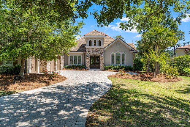 mediterranean / spanish house with a front lawn