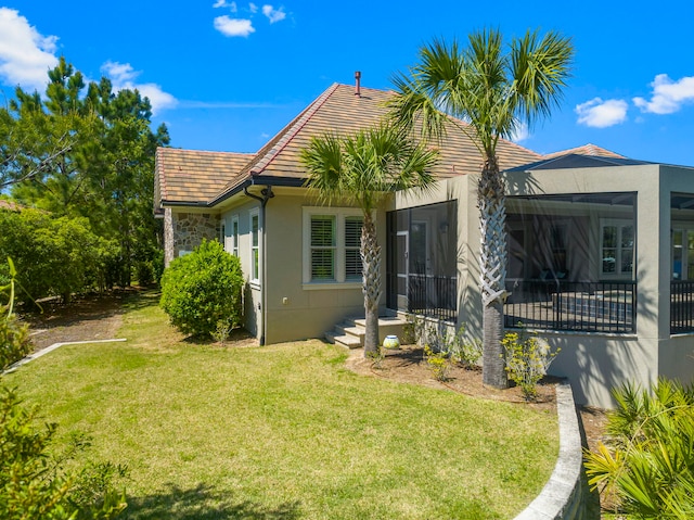 rear view of house featuring a lawn