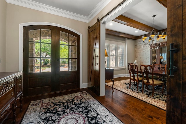 entryway with french doors, a barn door, beam ceiling, dark hardwood / wood-style flooring, and a chandelier