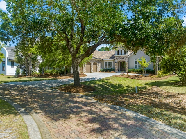 view of front facade featuring a front yard and a garage