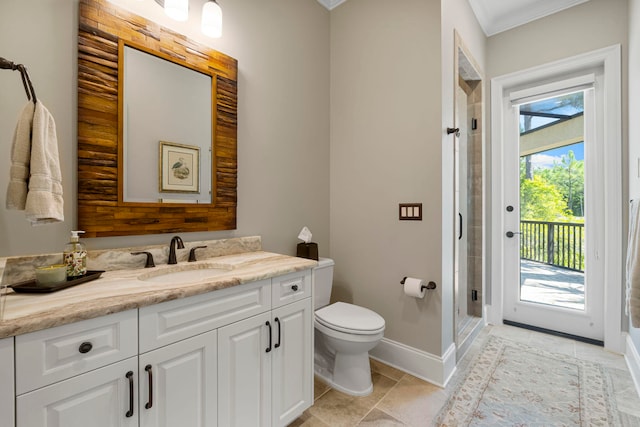 bathroom featuring a healthy amount of sunlight, vanity, toilet, and crown molding