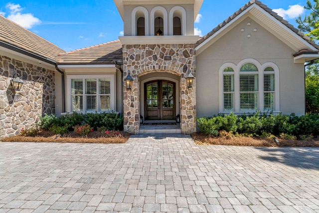 view of exterior entry featuring french doors