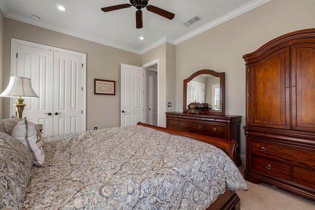 carpeted bedroom featuring ornamental molding, a closet, and ceiling fan