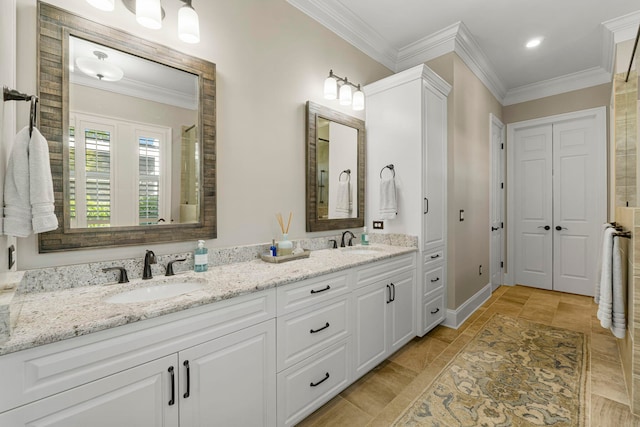 bathroom with ornamental molding, dual sinks, oversized vanity, and tile floors