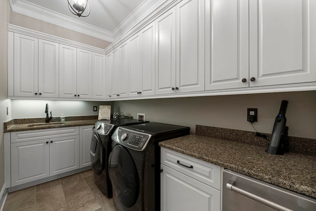 laundry room featuring washer and dryer, cabinets, light tile floors, sink, and ornamental molding