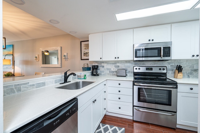 kitchen featuring sink, stainless steel appliances, dark hardwood / wood-style flooring, and white cabinetry