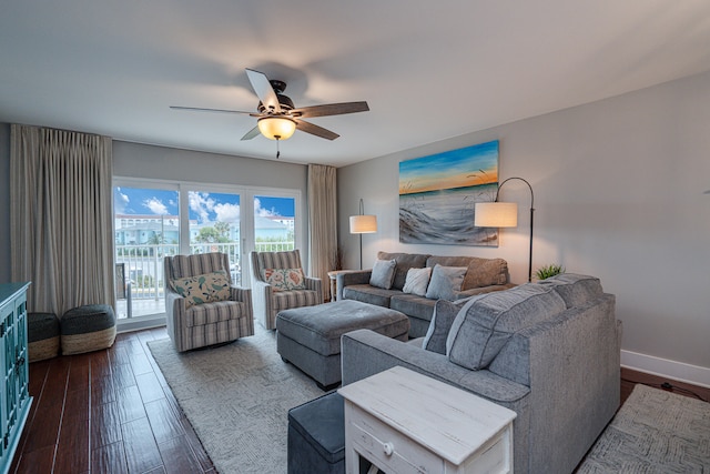 living room with dark hardwood / wood-style flooring and ceiling fan