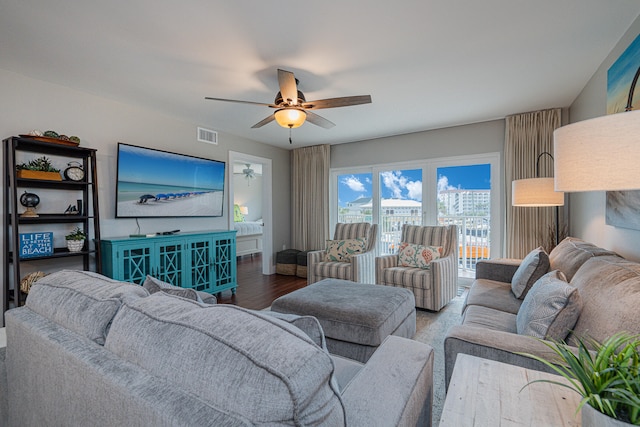 living room featuring wood-type flooring and ceiling fan