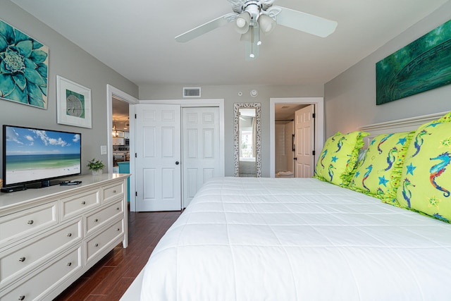 bedroom with a closet, dark wood-type flooring, and ceiling fan