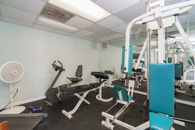 exercise room with a paneled ceiling