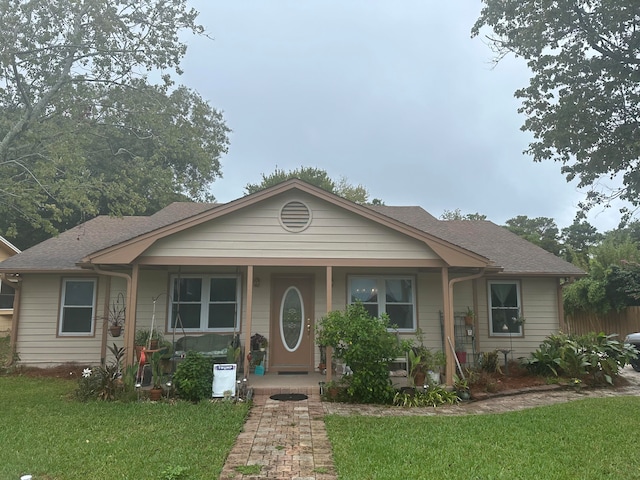 bungalow-style house with covered porch and a front lawn