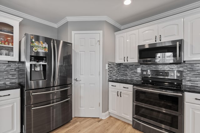 kitchen with appliances with stainless steel finishes, backsplash, light hardwood / wood-style floors, crown molding, and white cabinets