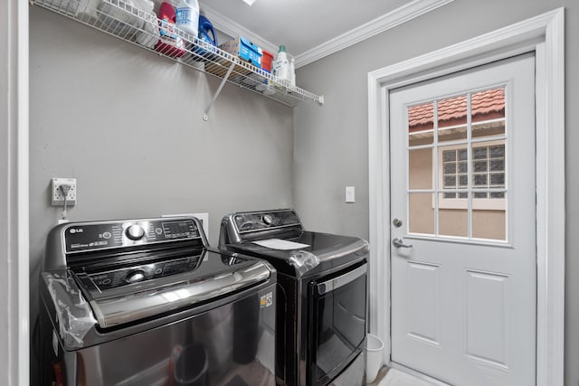 laundry room with washer and clothes dryer and crown molding