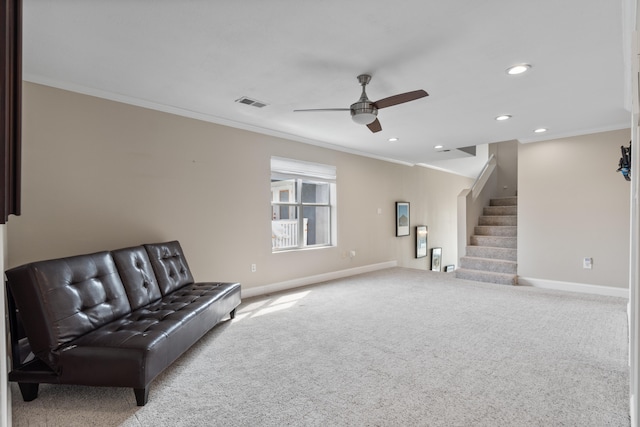 sitting room featuring ceiling fan, light carpet, and crown molding