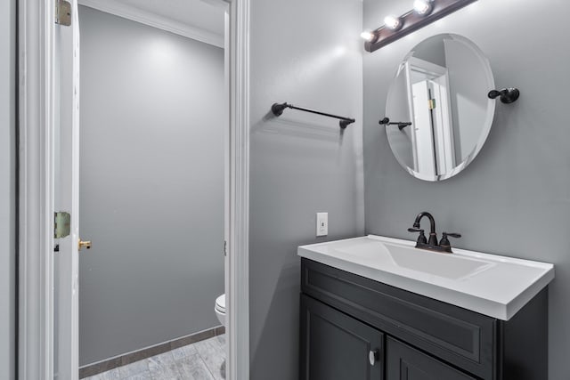 bathroom featuring oversized vanity, hardwood / wood-style floors, and toilet