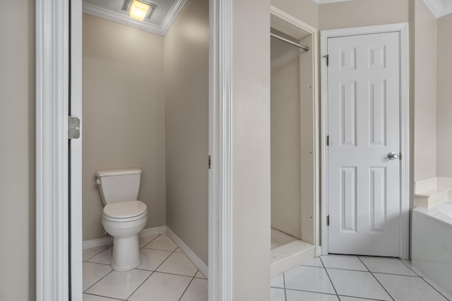 bathroom featuring crown molding, toilet, and tile floors