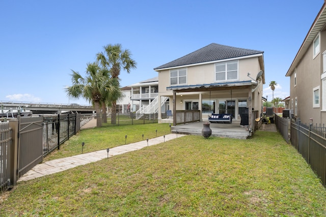 rear view of house featuring a patio, a deck, central air condition unit, and a lawn