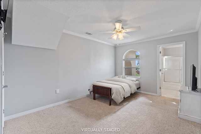 carpeted bedroom with ornamental molding, ceiling fan, ensuite bath, and a textured ceiling