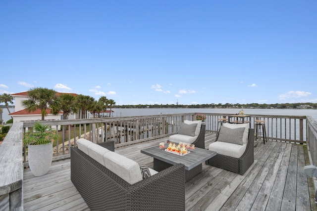 wooden deck with outdoor lounge area and a water view