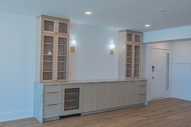 interior space with light stone counters and light wood-type flooring