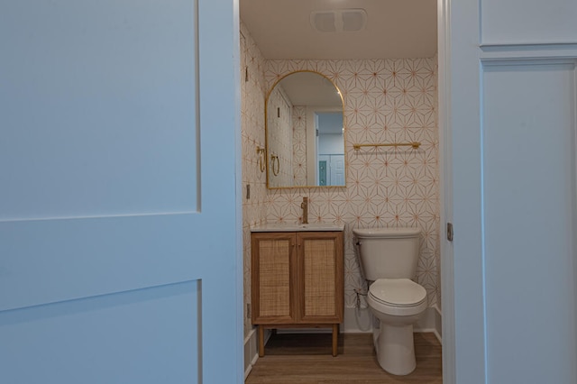 bathroom featuring tile walls, hardwood / wood-style floors, and toilet