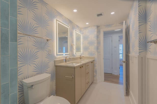 bathroom with vanity, toilet, and tile flooring