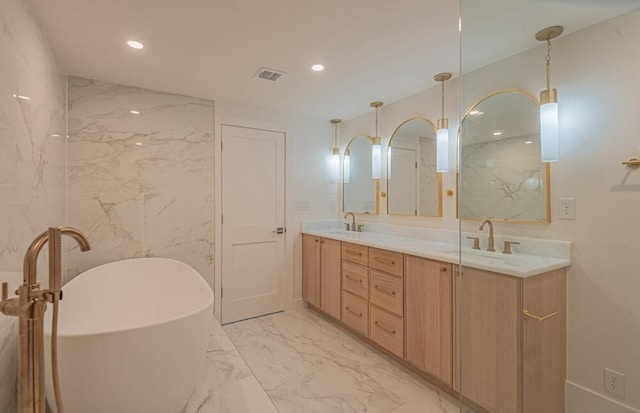 bathroom featuring a bathing tub, double vanity, tile floors, and tile walls