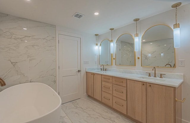 bathroom with double vanity, tile flooring, tile walls, and a tub