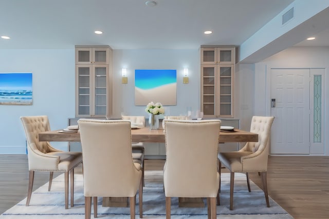 dining space with hardwood / wood-style floors