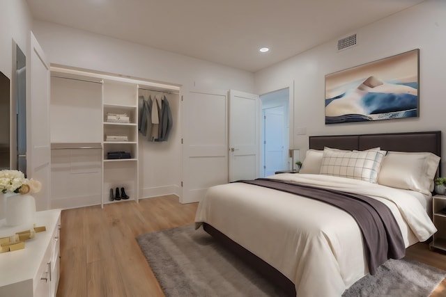 bedroom featuring a closet and light hardwood / wood-style floors