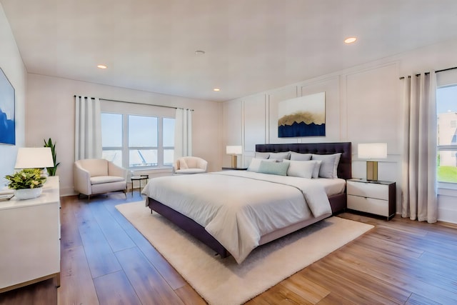 bedroom featuring light hardwood / wood-style flooring and multiple windows