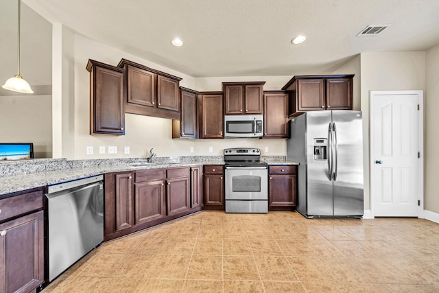 kitchen featuring sink, stainless steel appliances, light stone counters, pendant lighting, and light tile patterned floors