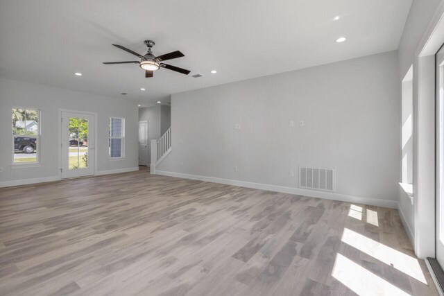 unfurnished living room featuring light hardwood / wood-style floors and ceiling fan