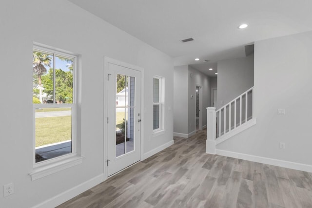 foyer entrance with light hardwood / wood-style flooring