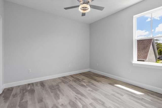 spare room with light hardwood / wood-style floors and ceiling fan