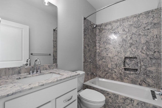 full bathroom with vanity, tiled shower / bath, and toilet