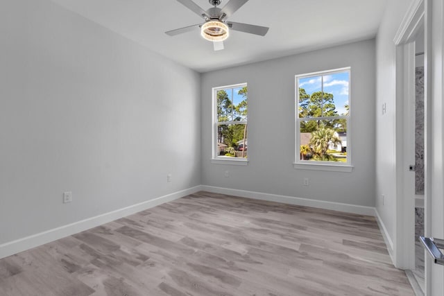 spare room featuring light hardwood / wood-style floors and ceiling fan