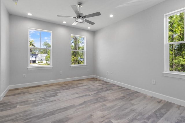 spare room featuring ceiling fan and light hardwood / wood-style floors