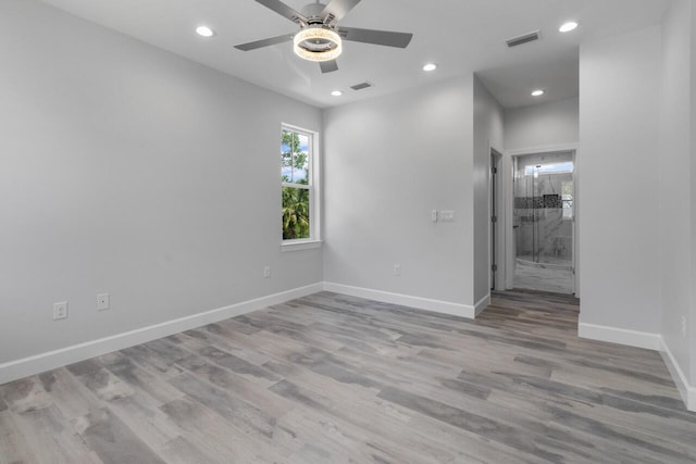 spare room featuring light hardwood / wood-style floors and ceiling fan