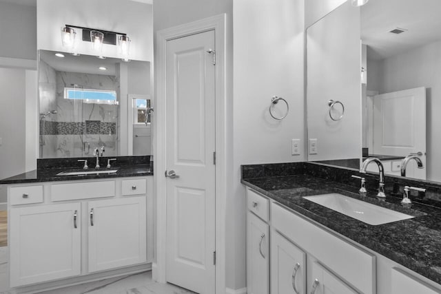 bathroom featuring an enclosed shower and vanity