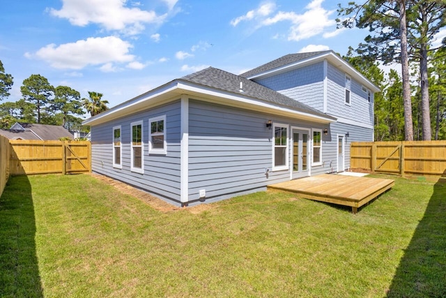 back of property featuring a deck and a yard