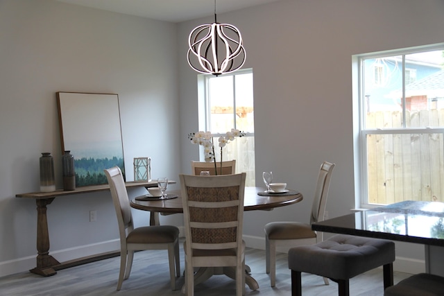 dining space featuring a notable chandelier and wood-type flooring