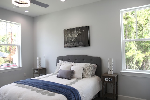 bedroom with multiple windows and ceiling fan