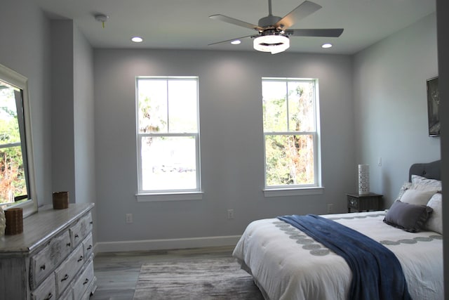 bedroom with light wood-type flooring and ceiling fan