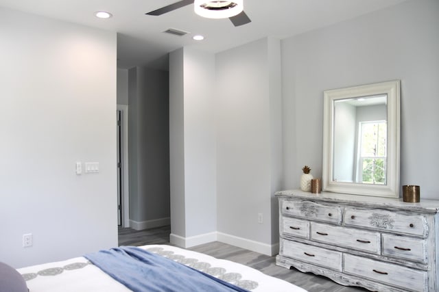 bedroom with ceiling fan and dark hardwood / wood-style floors