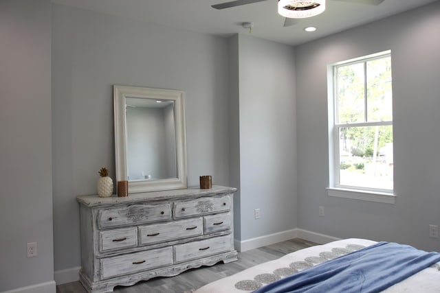 bedroom with light hardwood / wood-style floors and ceiling fan